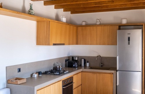 Exomvourgo House | A house in an olive grove with a unique view to the Aegean sea.
