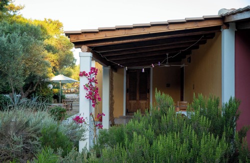 Vasilikos Cottage | Self catered cottage with large veranda and garden with hammock near the beach.