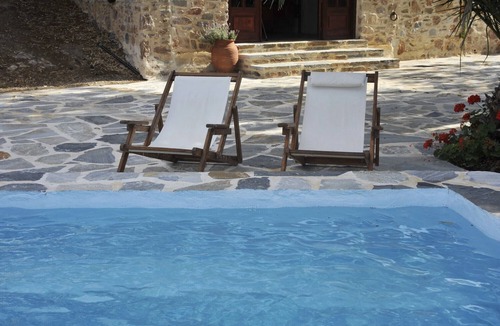 Syros Cottage | Stone-built studio under two Eucalyptus trees.