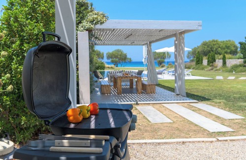 Soroni Villa | Stunning beachfront retreat, private tennis court & infinity pool