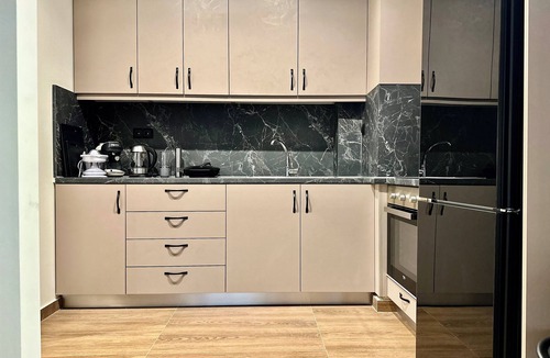 Petralona Apartment | T&T Black Wood & Gold Elegance