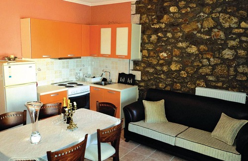 Paralia House | This stone vacation property on two levels is one of three terraced houses sharing a swimming pool.