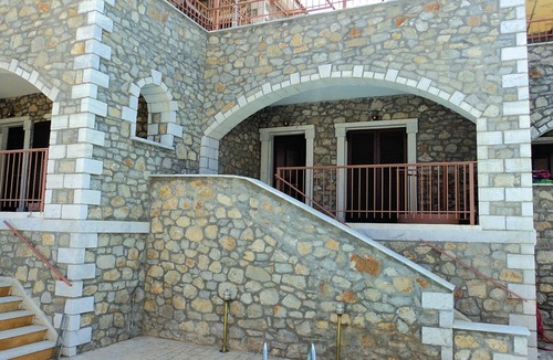 Paralia House | This stone vacation property on two levels is one of three terraced houses sharing a swimming pool.