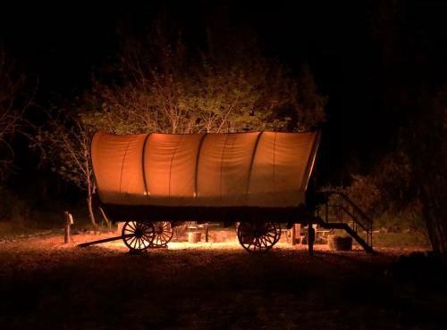 Cozy Wild West Covered Wagon next to River in Grants Pass